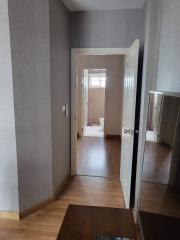 Interior view of a residential hallway leading to rooms