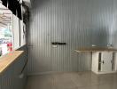 Compact commercial space with metal walls and wooden countertops