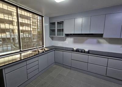 Modern kitchen with stainless steel appliances and grey cabinets