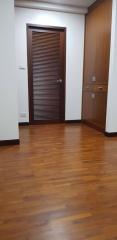 Spacious room with wooden flooring and modern door
