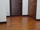 Spacious room with wooden flooring and modern door