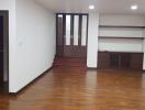Spacious unfurnished living room with wooden flooring