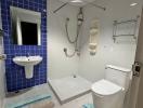 Modern white tiled bathroom with blue accents