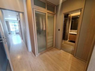 Spacious hallway with wooden flooring leading to rooms and bathroom