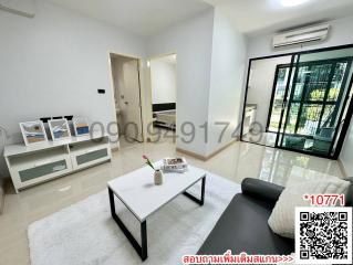 Spacious and well-lit living room with modern furniture and balcony access