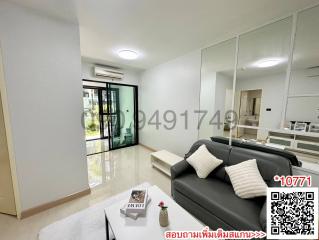 Spacious and modern living room with large mirror and comfortable sofa