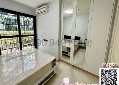 Well-lit bedroom with modern furniture and air conditioning