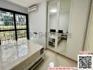 Well-lit bedroom with modern furniture and air conditioning