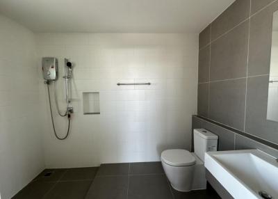 Modern bathroom with white tiles and walk-in shower