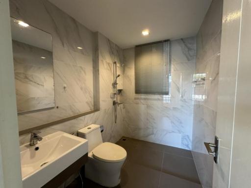 Modern bathroom with marble tiles and well-lit vanity area