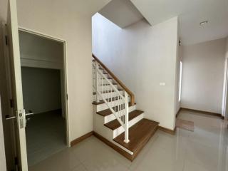Bright interior space with staircase leading to upper level