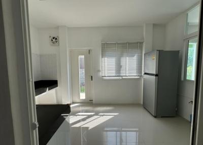 Bright modern kitchen with large window and tiled floor