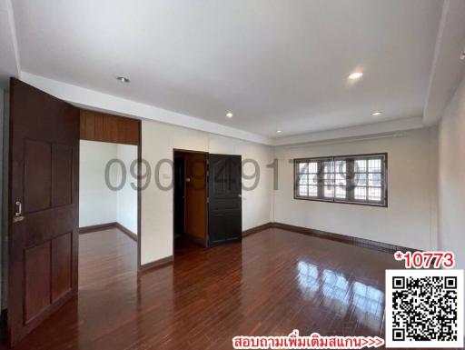 Spacious bedroom with hardwood floors and ample natural light