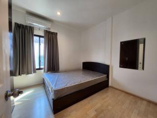 Modern bedroom with large window and parquet flooring