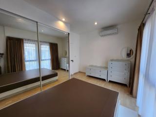 Spacious bedroom with mirror wardrobe and air conditioning unit