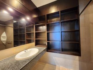 Spacious bathroom interior with large mirror and shelving unit