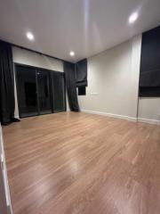 Modern bedroom with hardwood floors and large windows