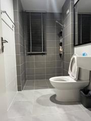 Modern bathroom with tiled flooring and walls