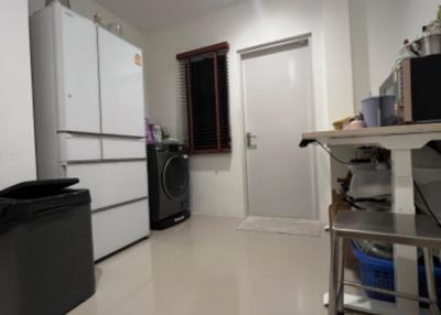 Compact kitchen with white appliances and tiled floor
