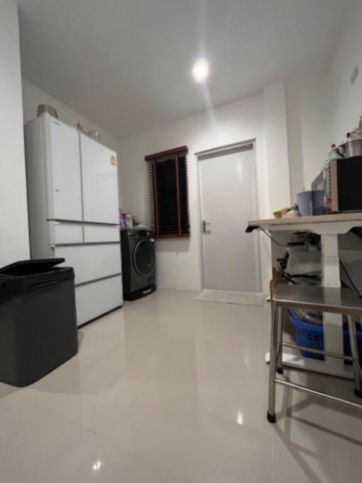 Compact kitchen with white appliances and tiled floor