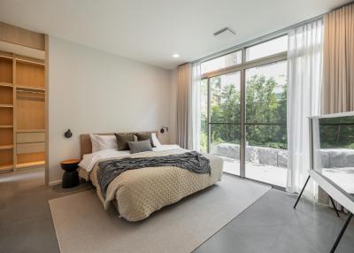 Modern bedroom with large window and ample natural light