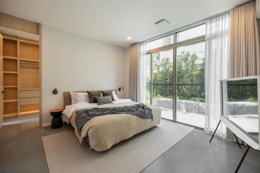 Modern bedroom with large window and ample natural light