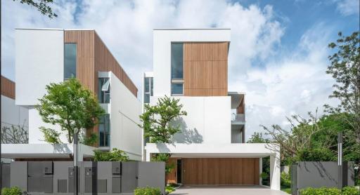 Modern residential building with wooden accents and landscaped front