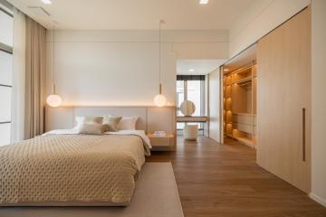 Modern bedroom with built-in wardrobe and soft natural lighting