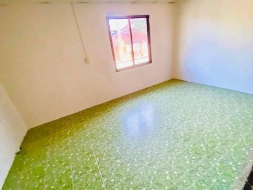 Bright bedroom with green tiled flooring and window