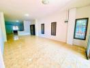 Spacious and well-lit empty living room with tiled flooring