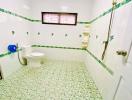 Spacious bathroom with green tile accents and natural light