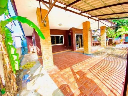 Spacious and well-lit home exterior with carport and terracotta tiles