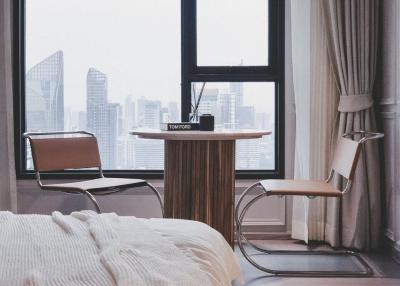 Modern bedroom with large window and city view