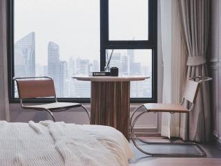 Modern bedroom with large window and city view