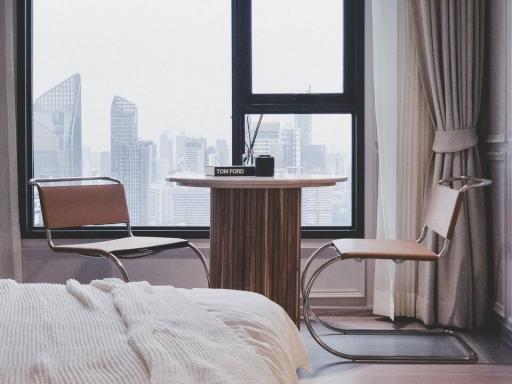 Modern bedroom with large window and city view