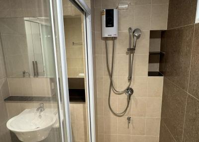 Modern bathroom interior with glass shower and ceramic tiles