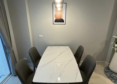 Modern dining room with marble table and stylish pendant light