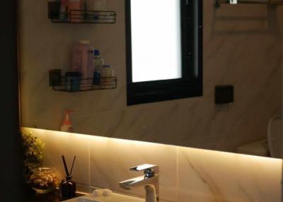 Modern bathroom interior with a well-lit vanity area