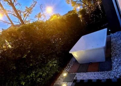 Peaceful garden area with pathway lighting at dusk
