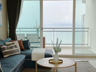 Cozy living room with ocean view and balcony access