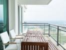 High-rise apartment balcony with wooden furniture and a panoramic view