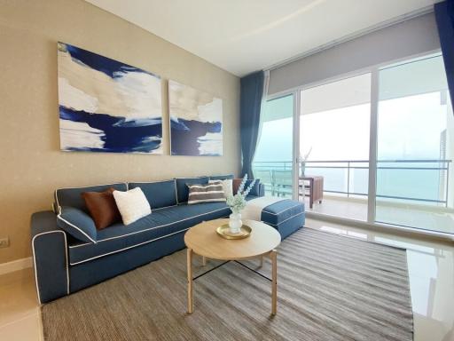 Modern living room interior with large windows and ocean view