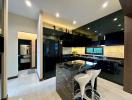 Modern kitchen with black cabinetry and marble countertops