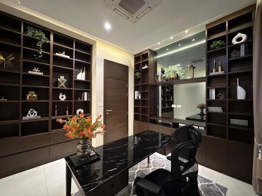 Sleek home office with dark wood shelves and marble desk