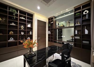 Sleek home office with dark wood shelves and marble desk