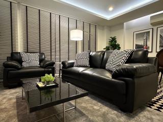 Modern living room interior with comfortable leather couches and stylish decor