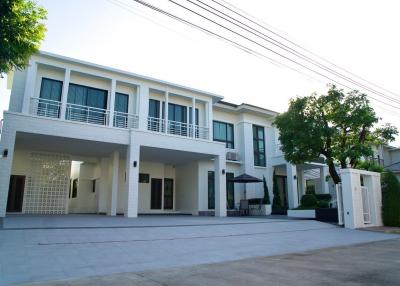 Modern two-story residential building viewed from the driveway