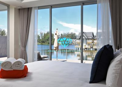 Modern bedroom with large windows overlooking the water