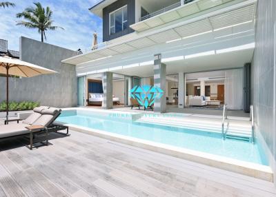 Luxurious outdoor pool area with adjacent lounge space and sliding doors leading to the living room