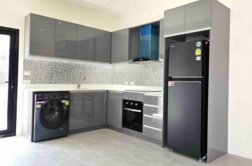 Modern kitchen with stainless steel appliances and gray cabinetry